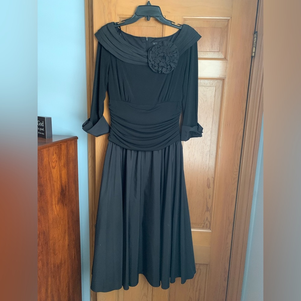 Black tea length dress with 3/4 sleeves.  Only worn once: